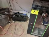a small refrigerator with a lot of wires on the floor