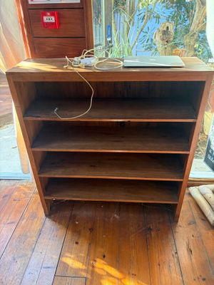 a wooden shelf with a laptop on top of it