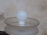 a glass bowl with a white ball on top of it