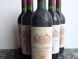 several bottles of wine are lined up on a table