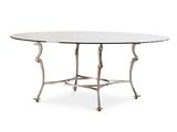 une table à manger ovale avec un plateau en verre et des pieds en métal