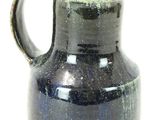 a blue vase with a brown handle on a white background