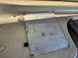 a piece of metal on the floor of a car