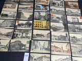 a lot of old postcards on a black table