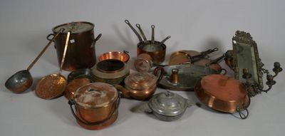 a pile of copper pots and pans on a table