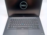 a close up of a dell laptop computer on a white surface