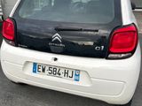 une petite voiture blanche garée dans un parking