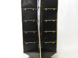 a black and gold display case on a pedestal