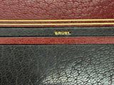 a close up of a black and red purse on a table