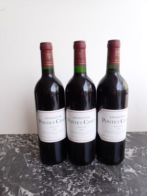 three bottles of wine sitting on top of a table next to each other