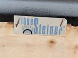 a sign that says roger steinerner on the back of a chair