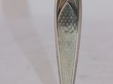 a silver vase that is sitting on a table