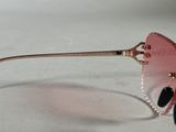 pink heart shaped sunglasses on a white surface with a pink background