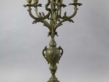 an antique bronze candelabra with green marble base