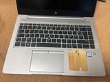 a laptop with a wooden sticker on the keyboard