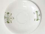 a white plate with a green design on it