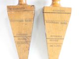 pair of antique wooden pegons with labels on them on a white surface