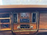 the dashboard of a car with wood paneling and a radio