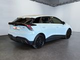 the rear end of a white car in a white room