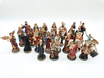 a lot of figurines that are sitting on a white surface