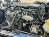 a close up of a car ' s engine with its hood open