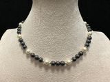 a black and white beaded necklace on a mannequin mannequin