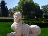 a statue of a lion sitting on a stone block