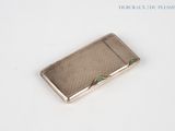 silver cigarette case with a green stone in the middle