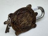 a metal padlock with a key attached to it