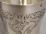 a silver cup with a heart on it on a table