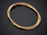 a gold bracelet with a knot on the end
