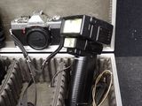 a suitcase with a camera and other items inside of it