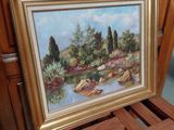 a picture of a painting on a wooden shelf next to a chair