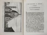 an open book with a drawing of a castle on it