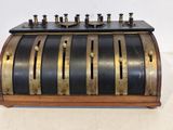 an old fashioned cash register with five coins in it