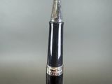 a black pen with a silver tip on a table