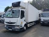 many white trucks parked in a parking lot