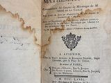 an old book with writing on it sitting on a marble surface