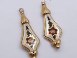 pair of gold and enamel earrings with floral designs on them