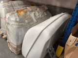 several pieces of luggage are stacked on top of a pallet in a warehouse