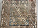 an old rug on the floor with a cat laying on it