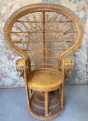 a wicker chair that is sitting in front of a wall