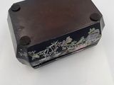 an old wooden box with a floral design on it