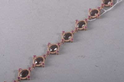 a close up of a bracelet with pink and gold beads