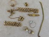 a lot of jewelry that is laying out on the floor