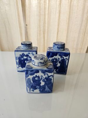 three blue and white vases sitting on a table