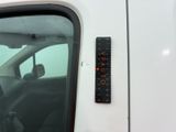 a remote control on the side of a white car