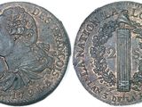 a silver coin with an image of a man in a crown on it