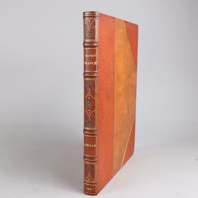 an old book sitting on top of a table with a white background