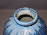 a blue and white vase sitting on a table